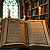 Post: The images depict a series of open books, each illuminated by flickering candlelight in dimly lit...